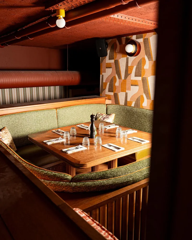 A set table and a banquette in Billy’s dining room